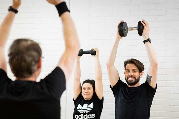 Class holidng weights above their heads