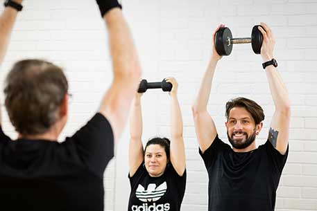 Class holidng weights above their heads