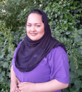 Staff member Asma standing in the nursery garden