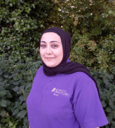 Staff member Aysha standing in the nursery garden