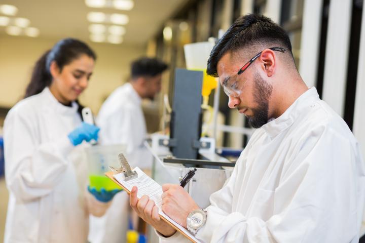 Two engineering students in a laboratory.