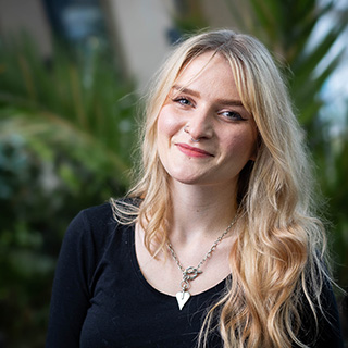 Molly, a Public Health and Community Wellbeing BSc student, smiling at the camera